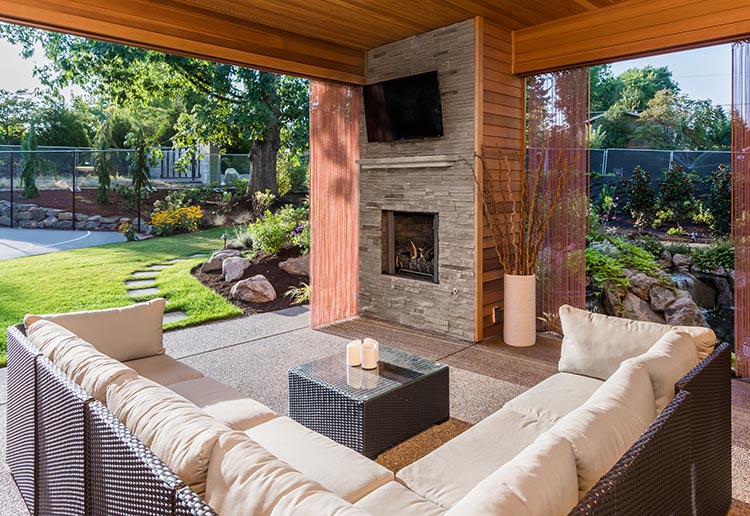 Beautiful covered patio outside new luxury home with television,